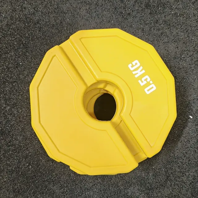 Quatre poids fractionnels jaunes annoncés à 0,5 kg